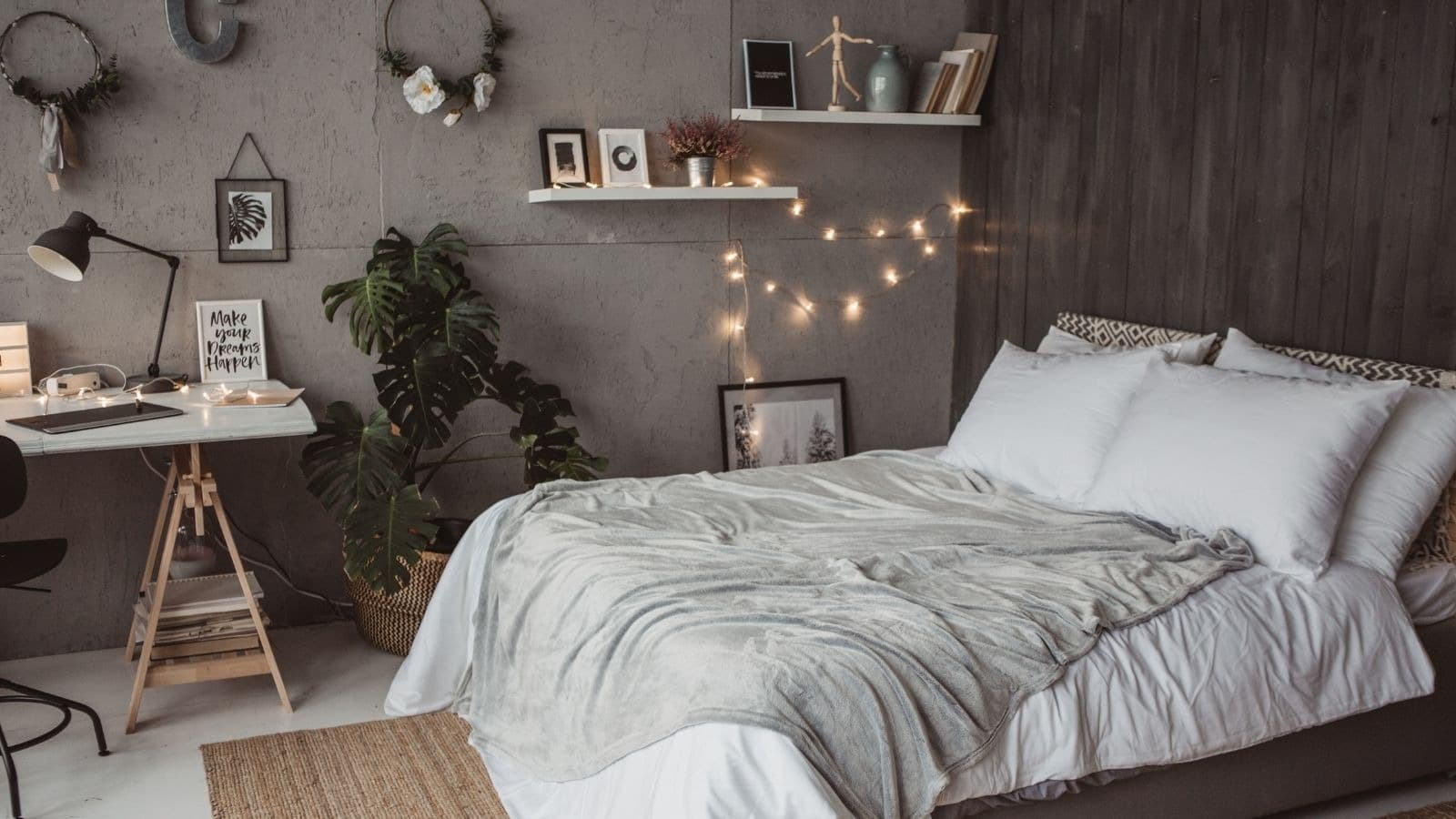 Chambre sombre avec lit défait et bureau
