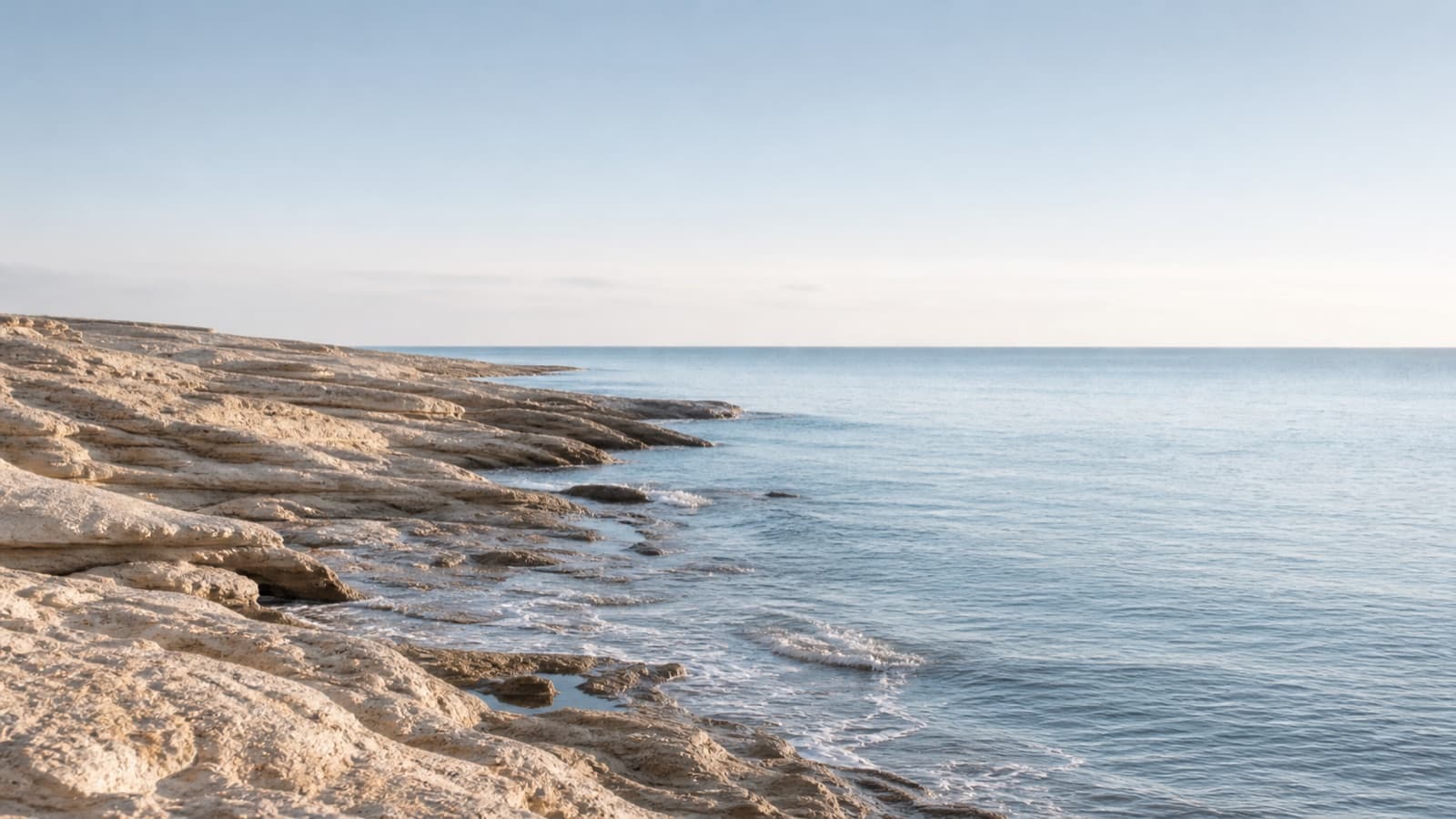 Côte rocheuse et mer calme dans une palette beige et bleue